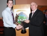 Liam Bradley presents the Gerry Dalrymple Memorial Cup for Senior Footballer of the Year to Benny Hasson